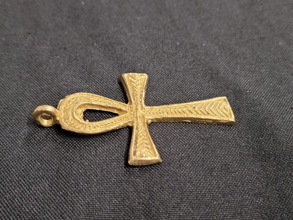 ghana brass ankh pendant side view dark background