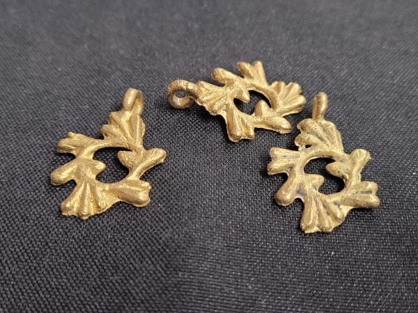 african brass pendant 3 adinkra symbol pendants gye nyame dark background