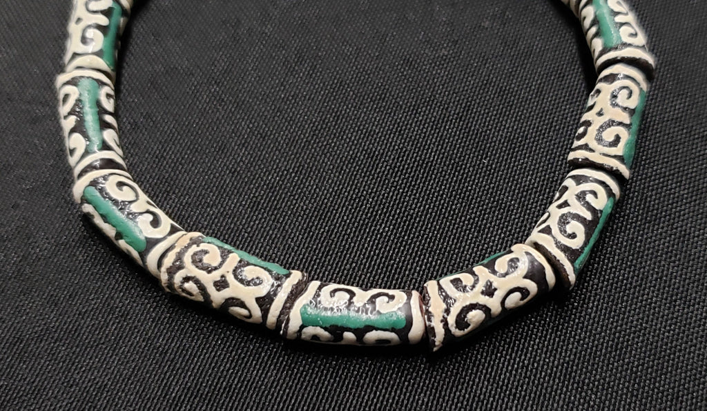 small adinkra glass beads ram horn ghana krobo green cream close up
