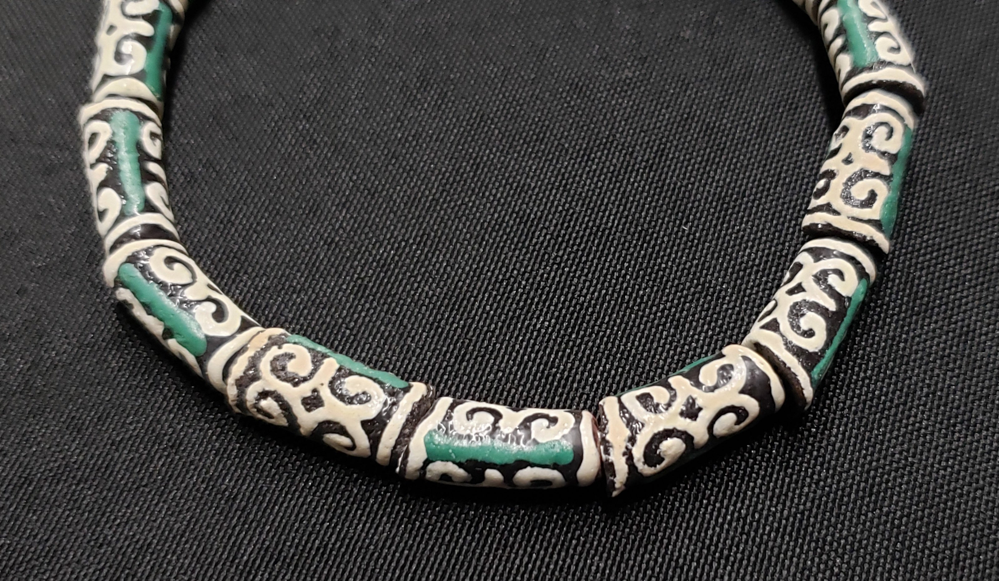 small adinkra glass beads ram horn ghana krobo green cream close up
