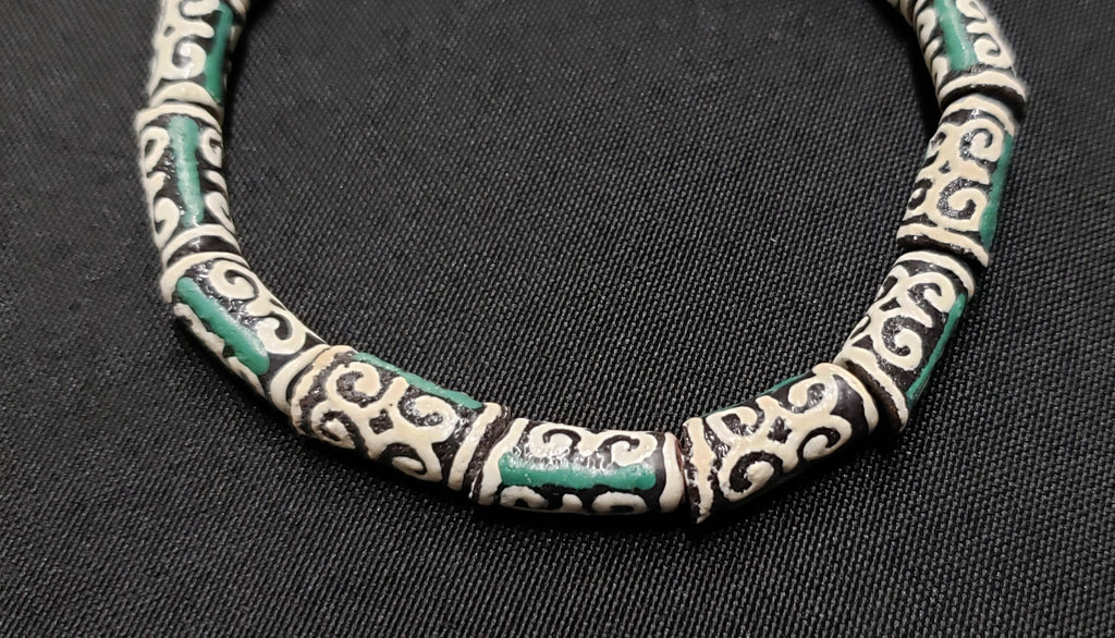 small adinkra glass beads ram horn ghana krobo green cream side view
