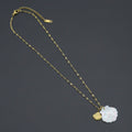 Fine gold-tone necklace with a white iridescent shell pendant and a smaller gold-tone shell charm