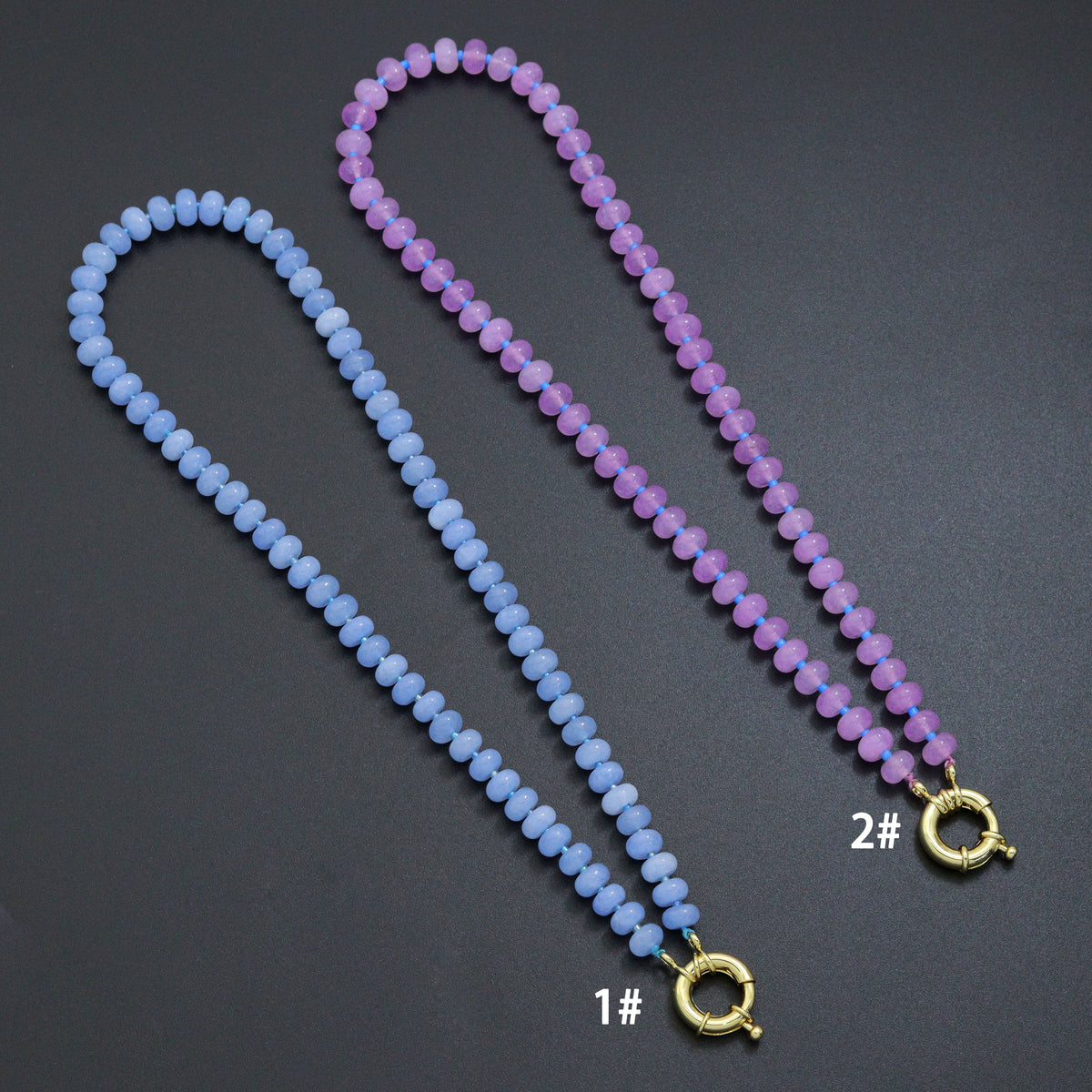 Blue and purple rondelle bead necklace with a gold-tone round clasp on a dark background