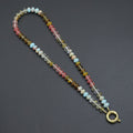 Multicolored rondelle bead necklace with pink, blue, clear and olive beads and a gold-tone round clasp