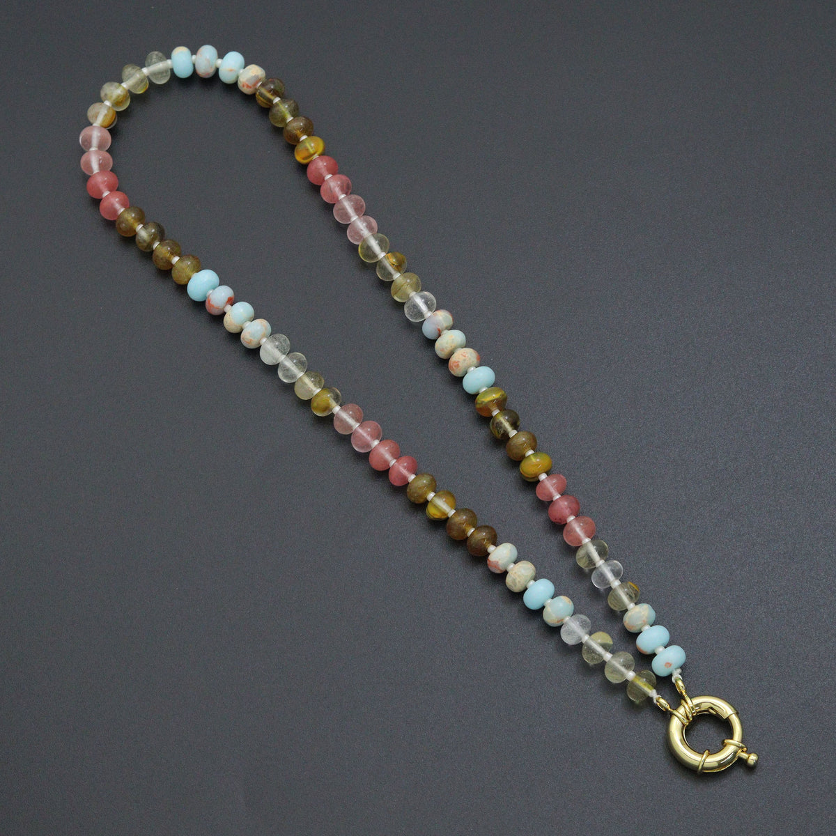 Multicolored rondelle bead necklace with pink, blue, clear and olive beads and a gold-tone round clasp