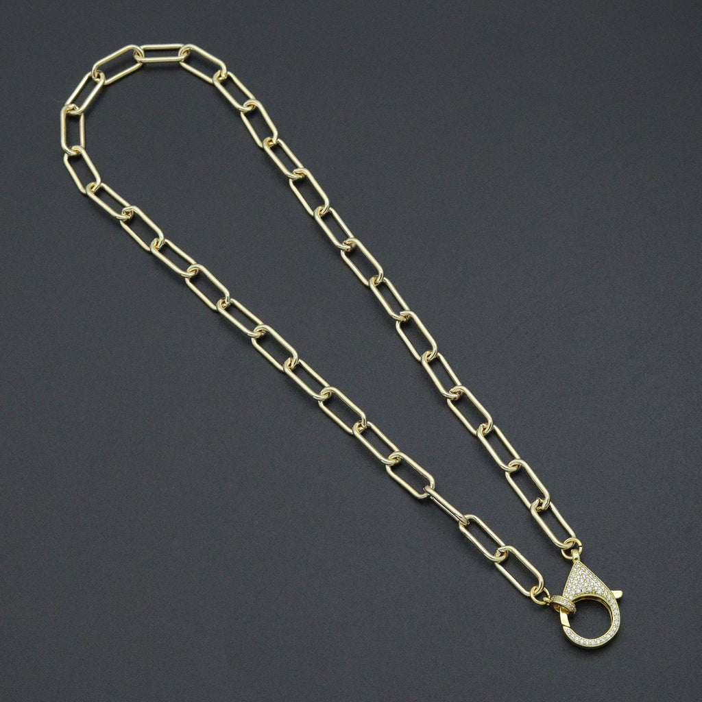 Gold-tone paperclip-link necklace with a large clear-stone lobster clasp