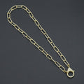 Gold-tone paperclip-link necklace with a large clear-stone lobster clasp