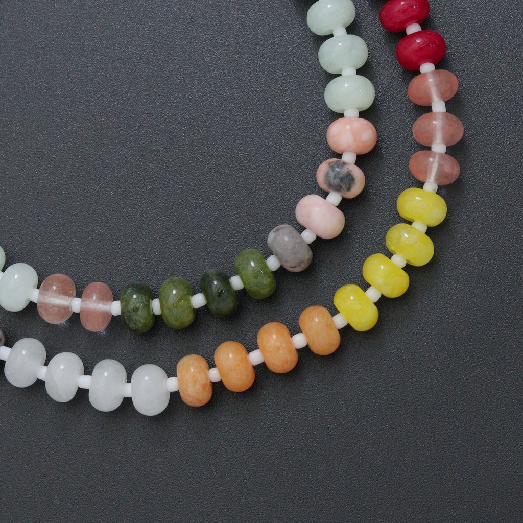 Close-up of multicolored rondelle beads separated by white spacers