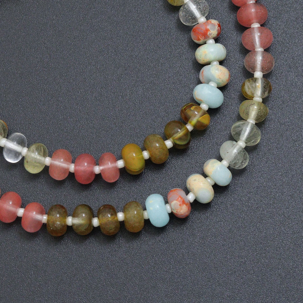 Close-up of pink, pale blue, clear and olive rondelle beads with white spacers