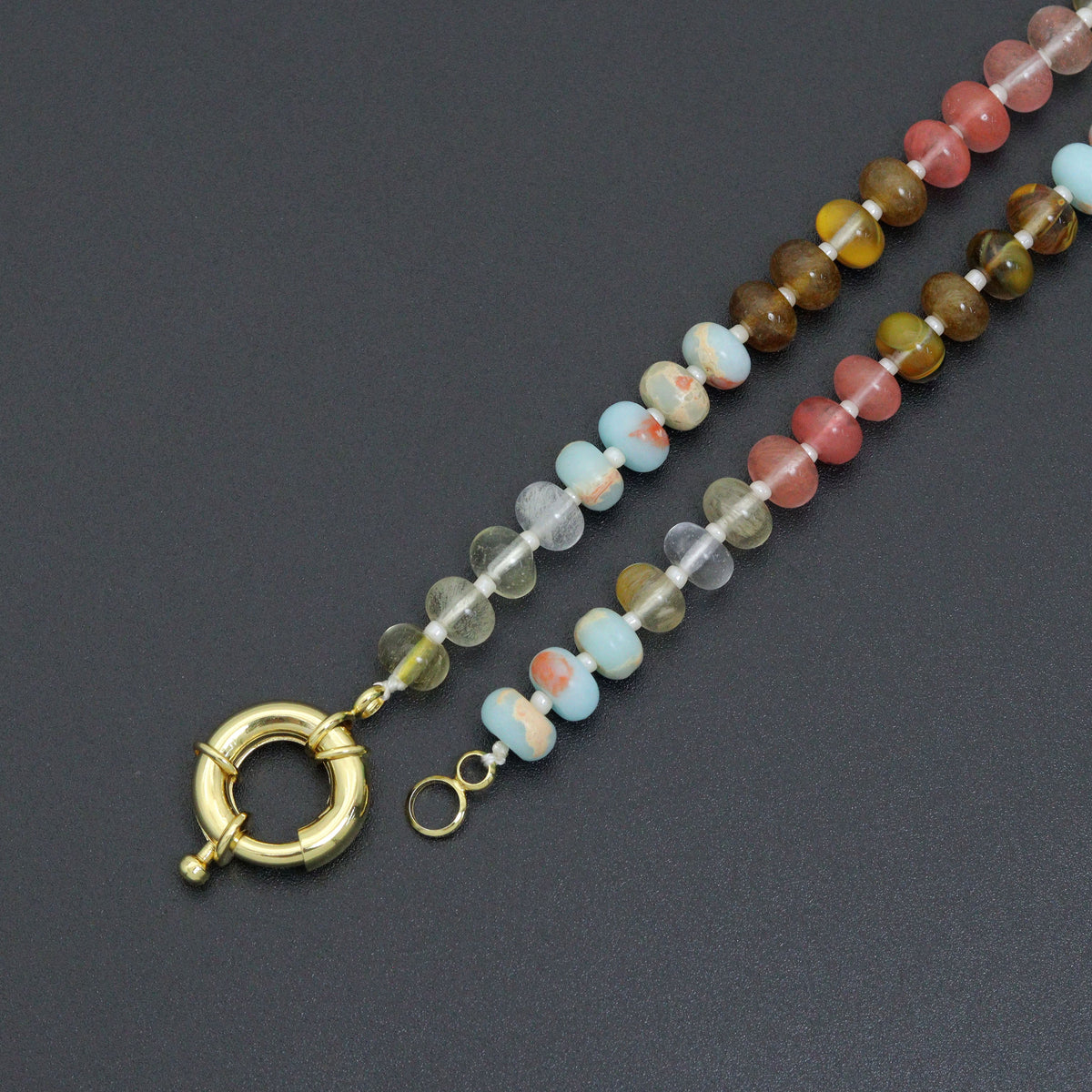 Multicolored bead necklace with its gold-tone round clasp unfastened