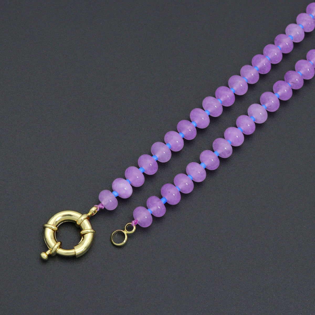 Close-up of the blue and purple bead necklace clasp and end rings