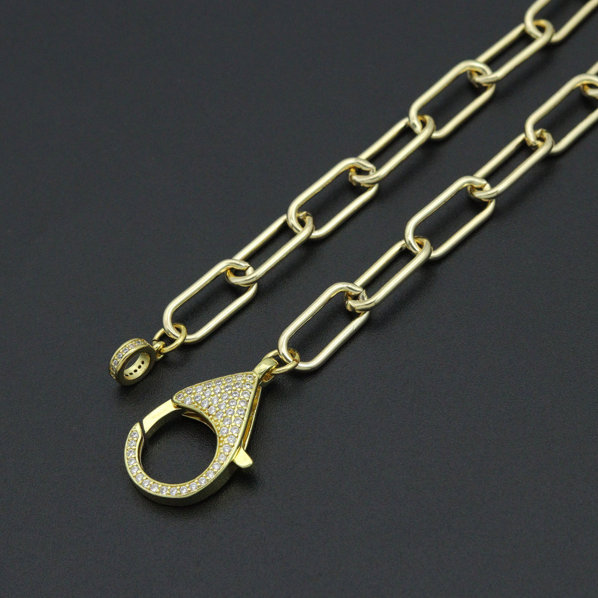 Close-up of the paperclip necklace clear-stone clasp and matching end ring