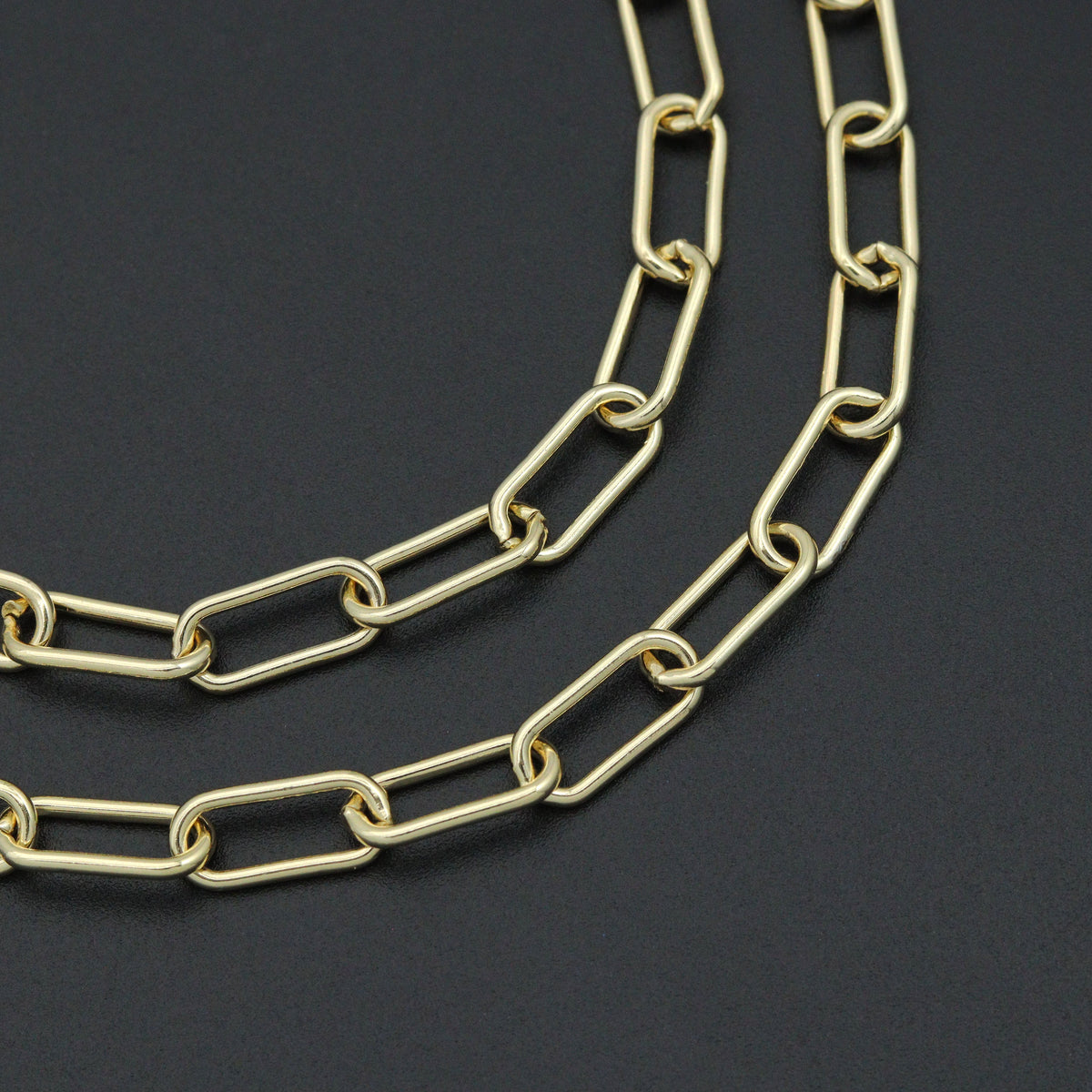 Close-up of elongated gold-tone paperclip chain links