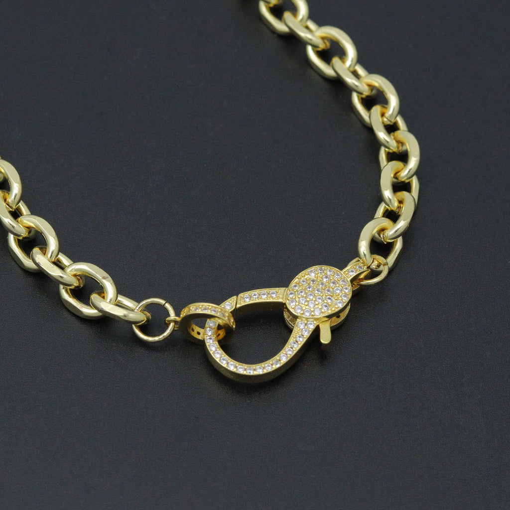 Close-up of a gold-tone rolo chain necklace sparkling lobster clasp