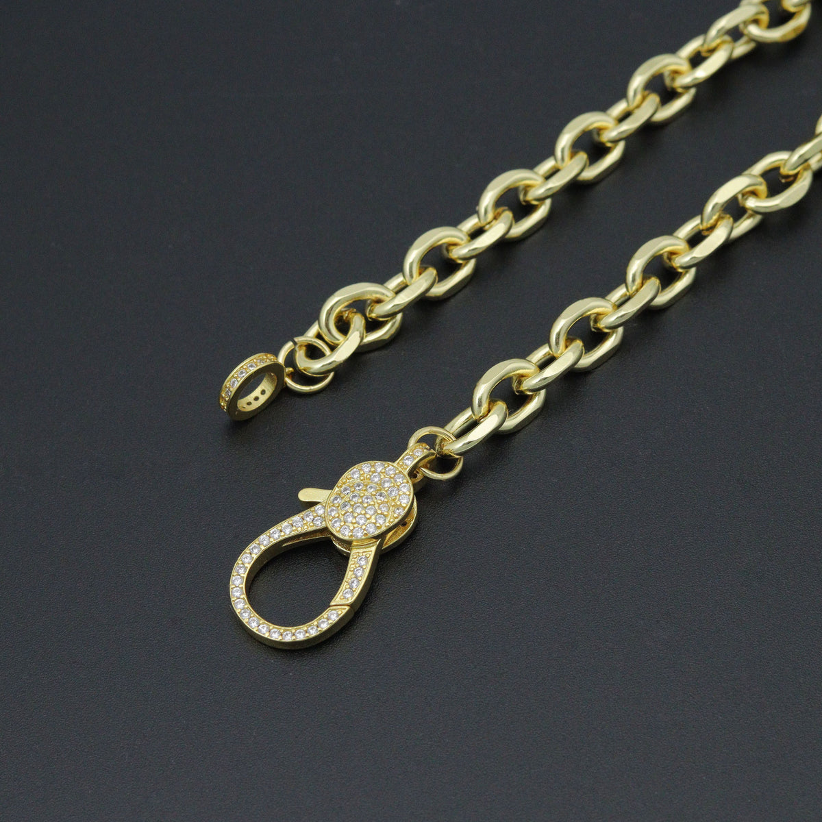 Rolo necklace showing its unfastened clear-stone clasp and matching end ring