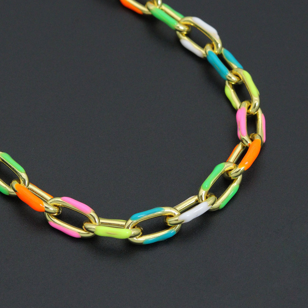 Close-up of gold-tone rectangular links with pink, orange, green and turquoise enamel accents