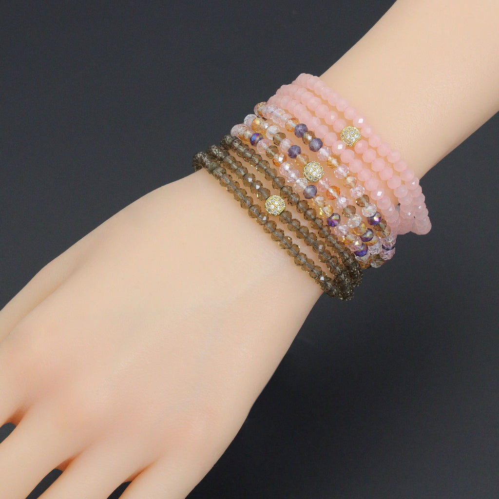 Three crystal bead wrap bracelets worn together on a wrist