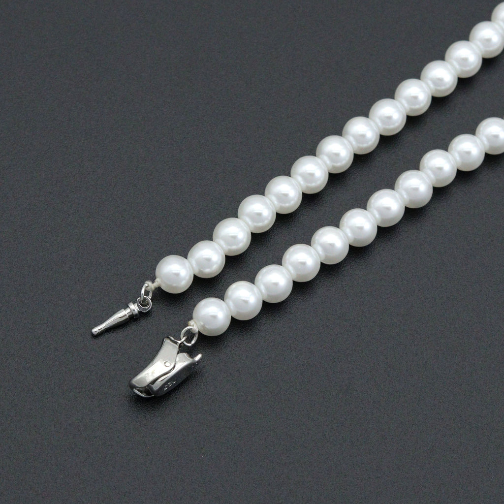Close-up of the pearl bead necklace open silver-tone clasp and white beads