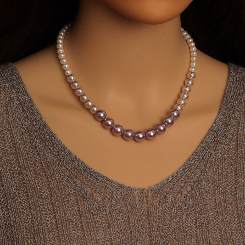 Purple gradient pearl bead necklace worn around the neck