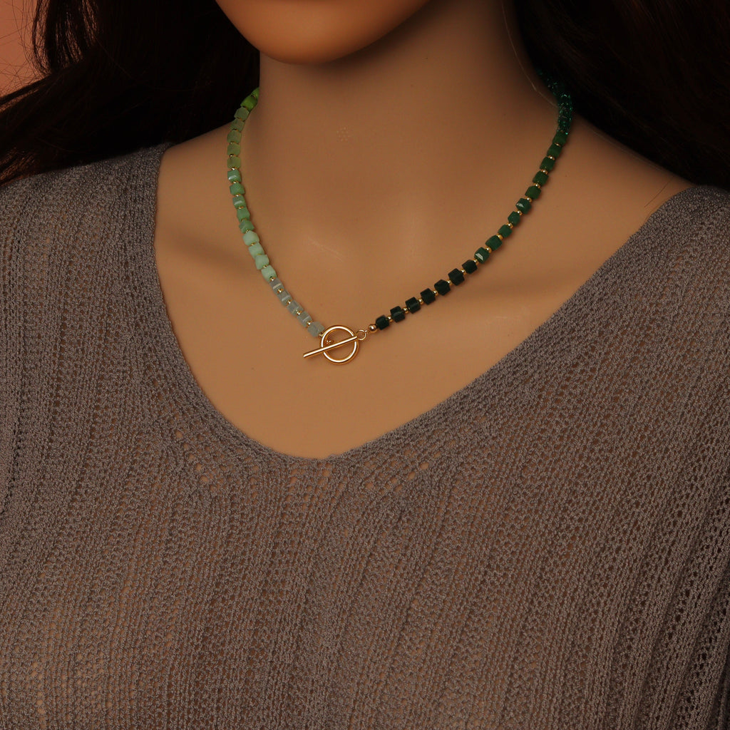 Ombré green cube bead necklace worn with the gold-tone toggle clasp at the front