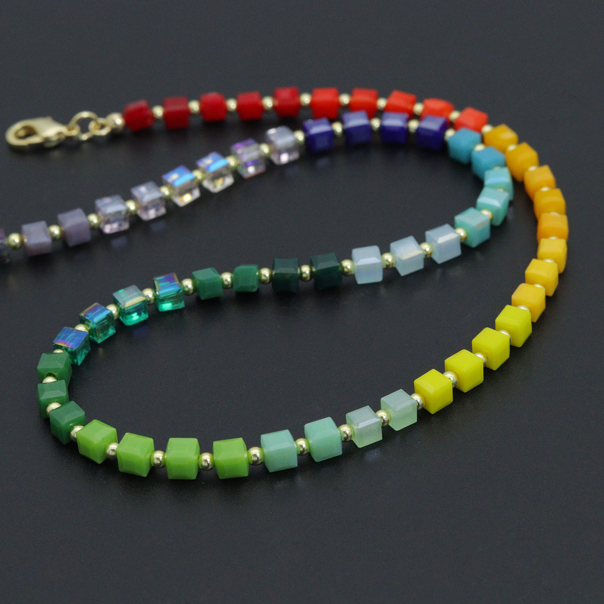 Close-up of multicolored cube beads and small gold-tone spacers