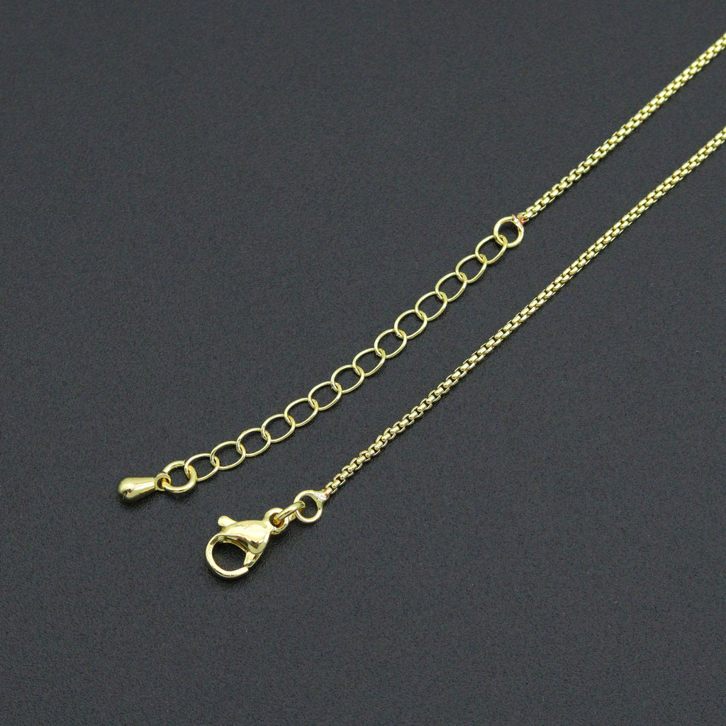 Close-up of the gold-tone box chain necklace lobster clasp and extender chain