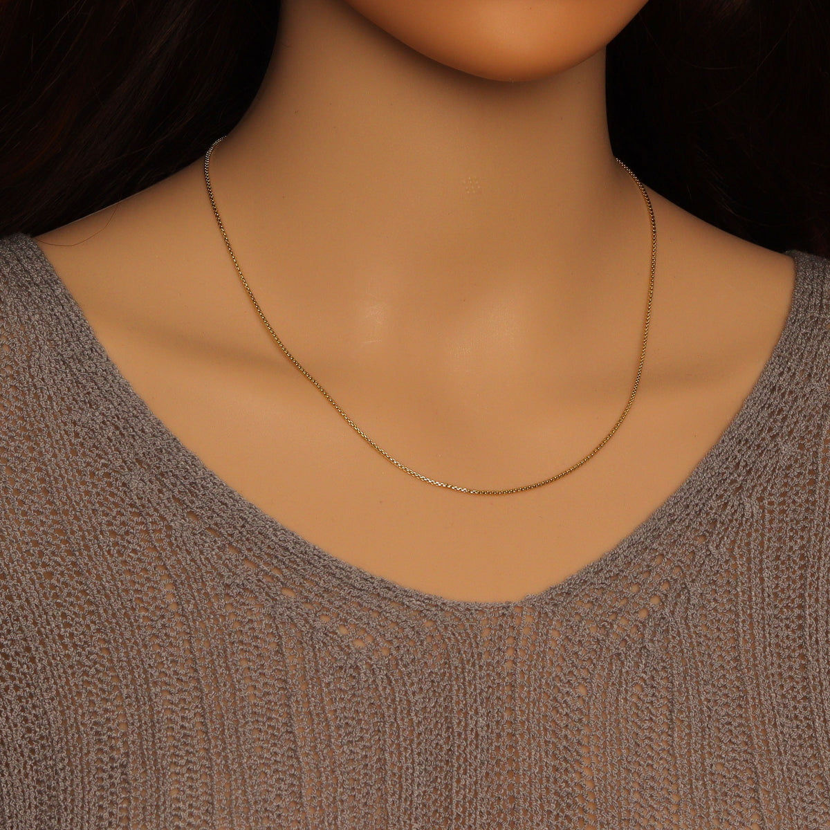 Gold-tone thin box chain necklace worn without a pendant
