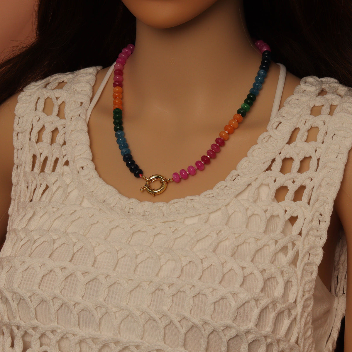 Pink and magenta rondelle bead necklace worn with its clasp at the front