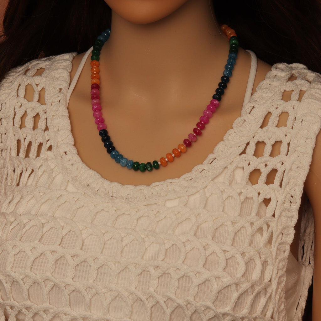 Green rondelle bead necklace worn with its clasp at the front
