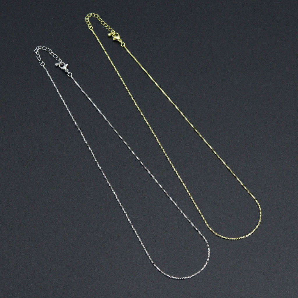 Gold-tone and silver-tone thin box chain necklaces with lobster clasps and extender chains