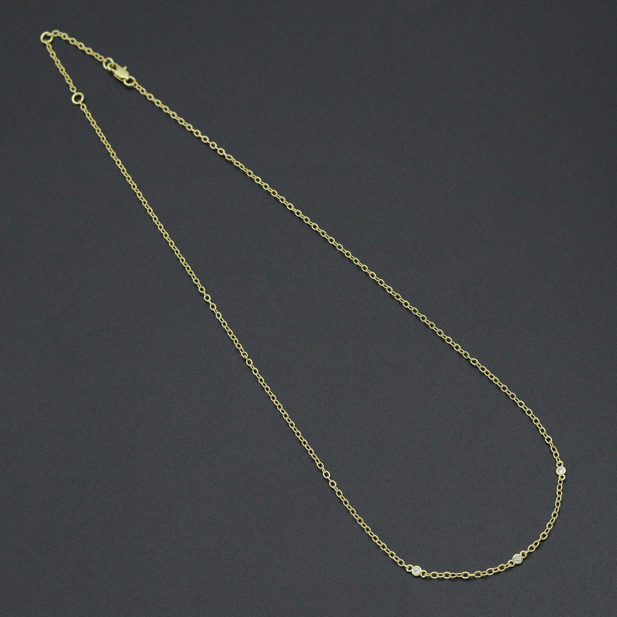 Dainty gold-tone link necklace with three round clear-stone bezel connectors