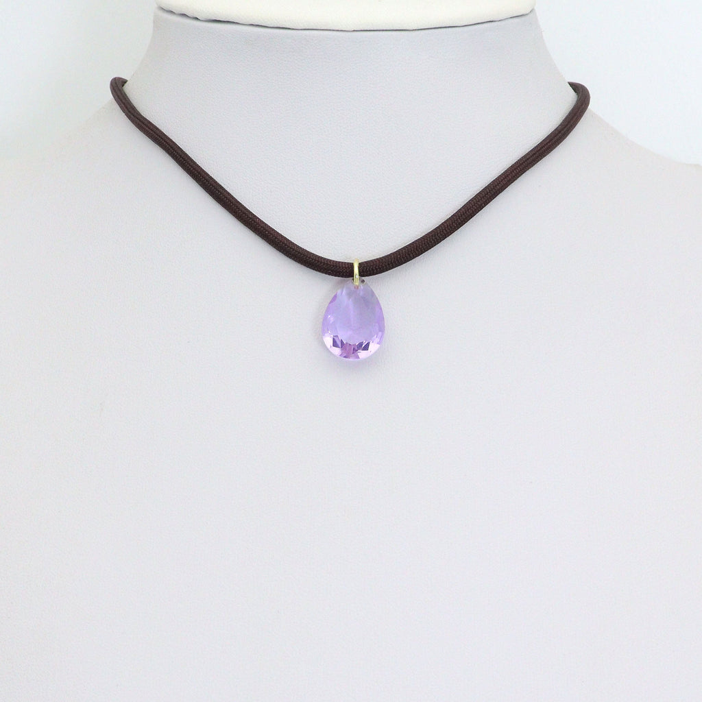 Dark cord necklace displaying a lavender teardrop pendant on a white bust