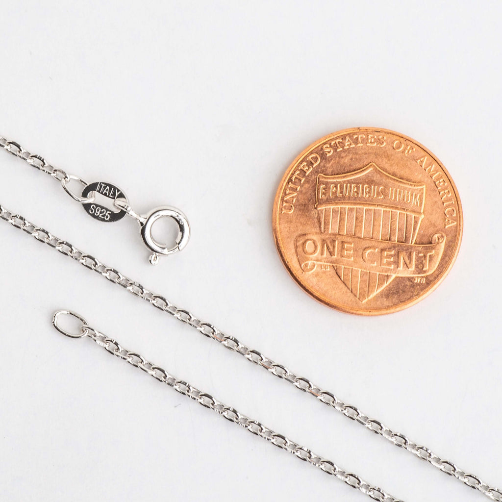 1.5mm cable chain clasp and end ring beside a penny