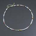 White pearl bead necklace with colorful small beads and gold-tone accents