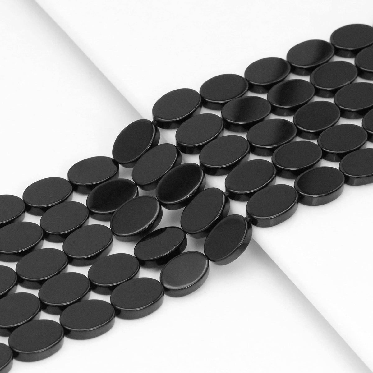 Black Onyx Smooth Flat Oval Beads, 8x12mm or 10x14mm, 15–16-Inch Strand