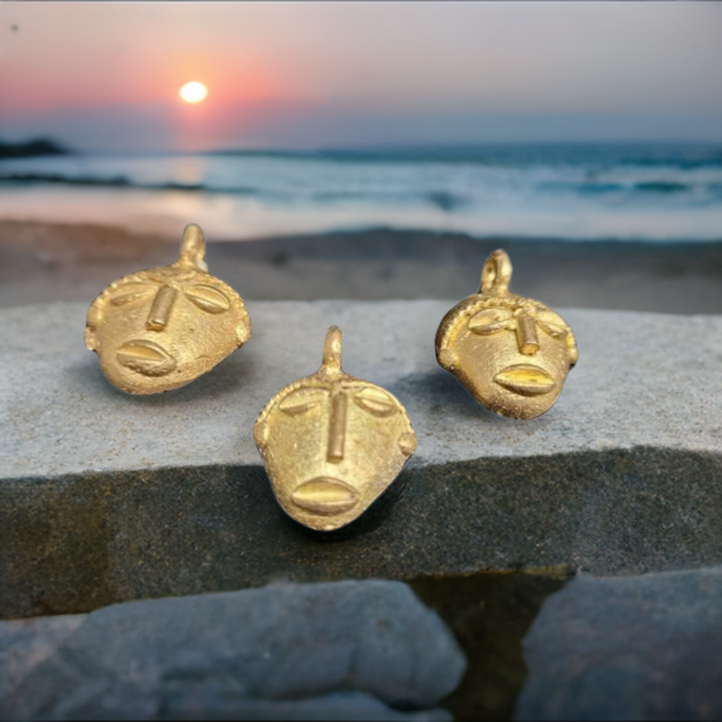 3 african brass small tribal mask pendants sunset background view 2