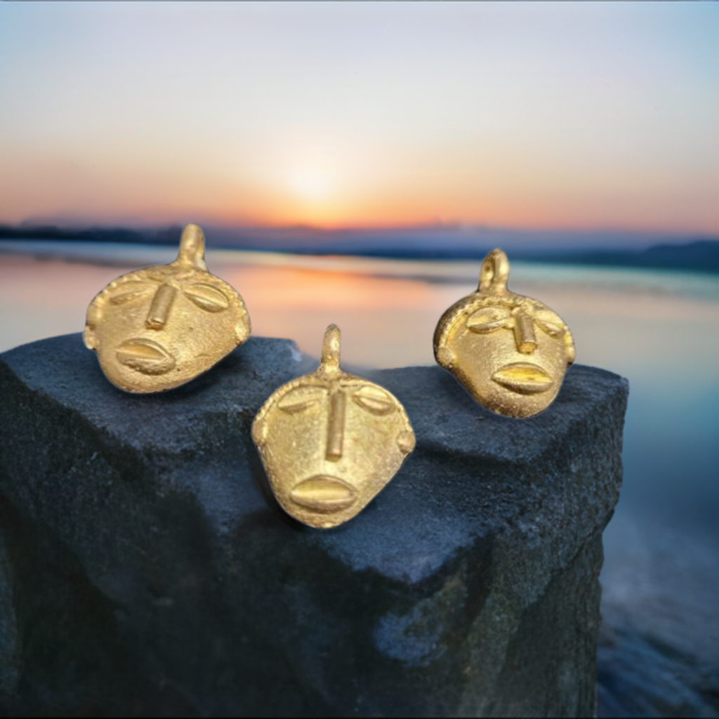 3 african brass small tribal mask pendants sunset background view 3