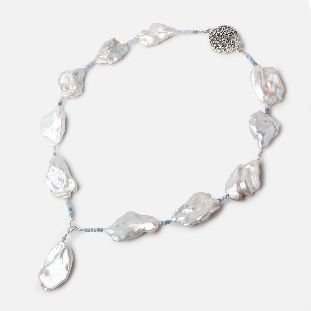 White irregular soufflé pearl necklace with pale blue spacer beads, a pearl drop and decorative silver-tone clasp