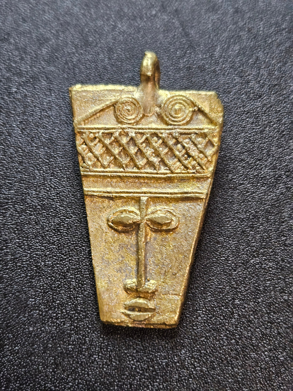 ashanti brass mask pendant ghanaian artisan detail
