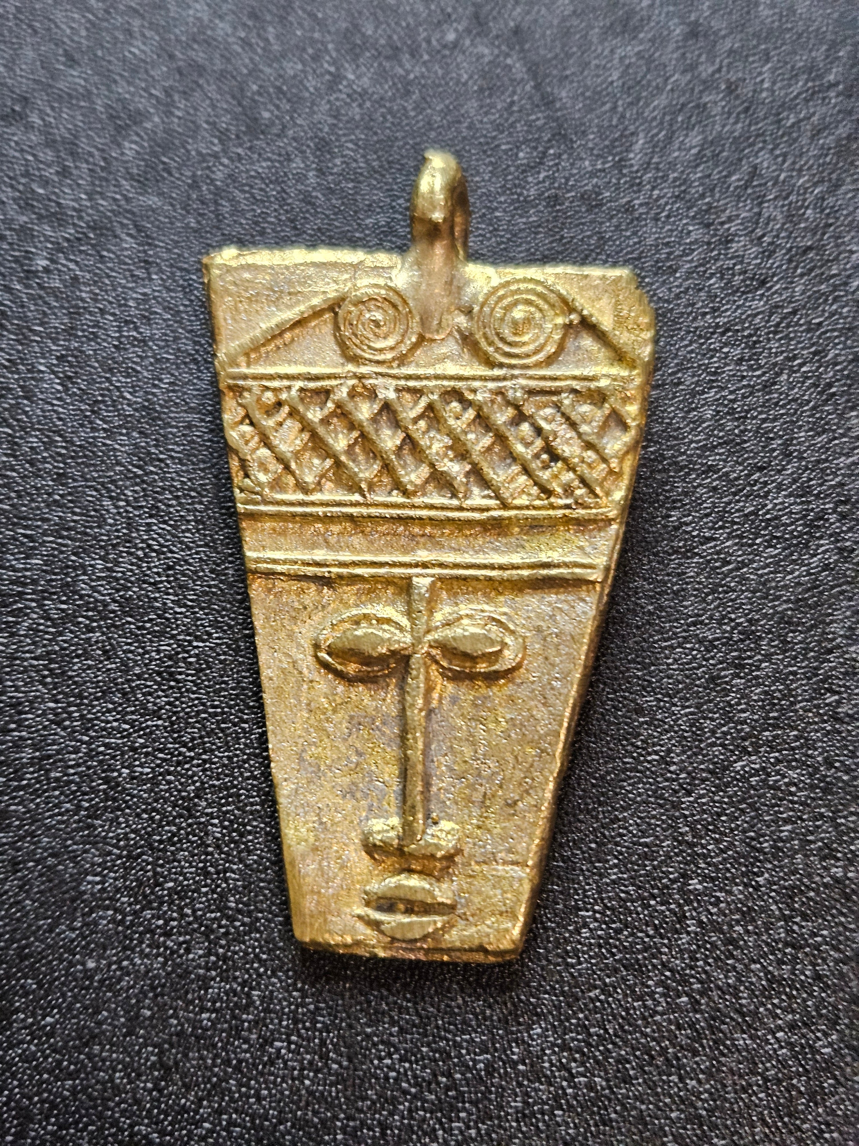 ashanti brass mask pendant ghanaian artisan detail