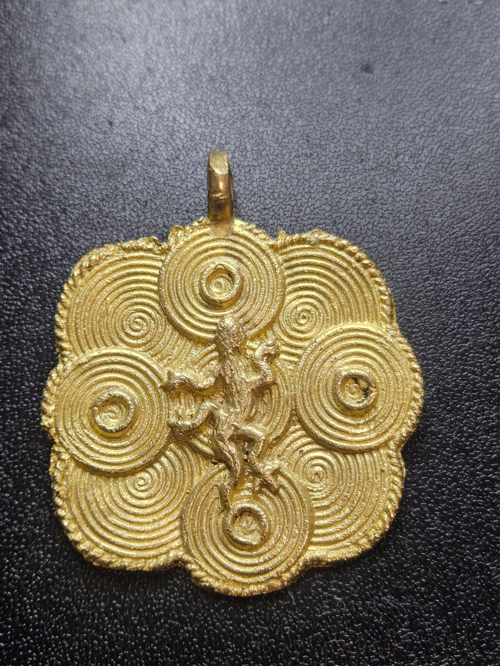 ashanti brass adinkra pendant symbol close up